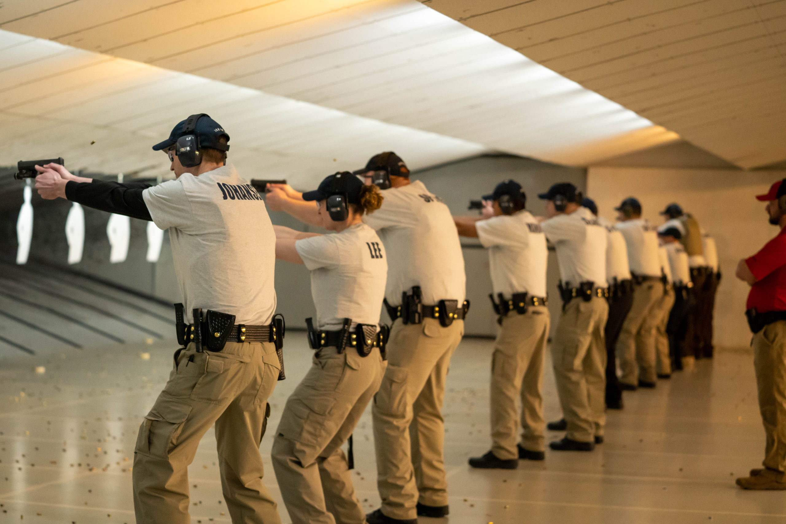 Cadets stand in a line and perform shooting exercises