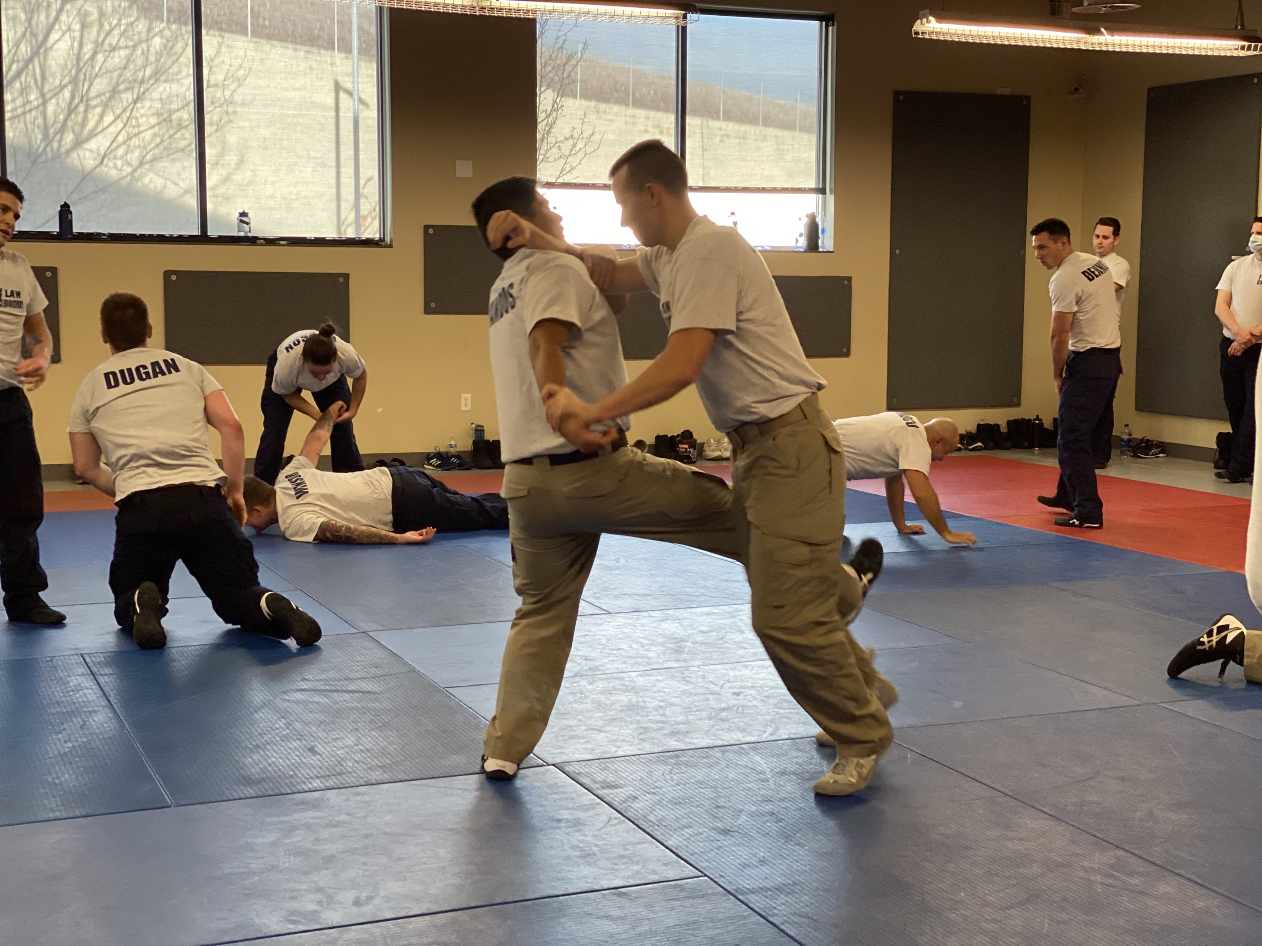 Two cadets perform defensive tactics maneuvers on each other.