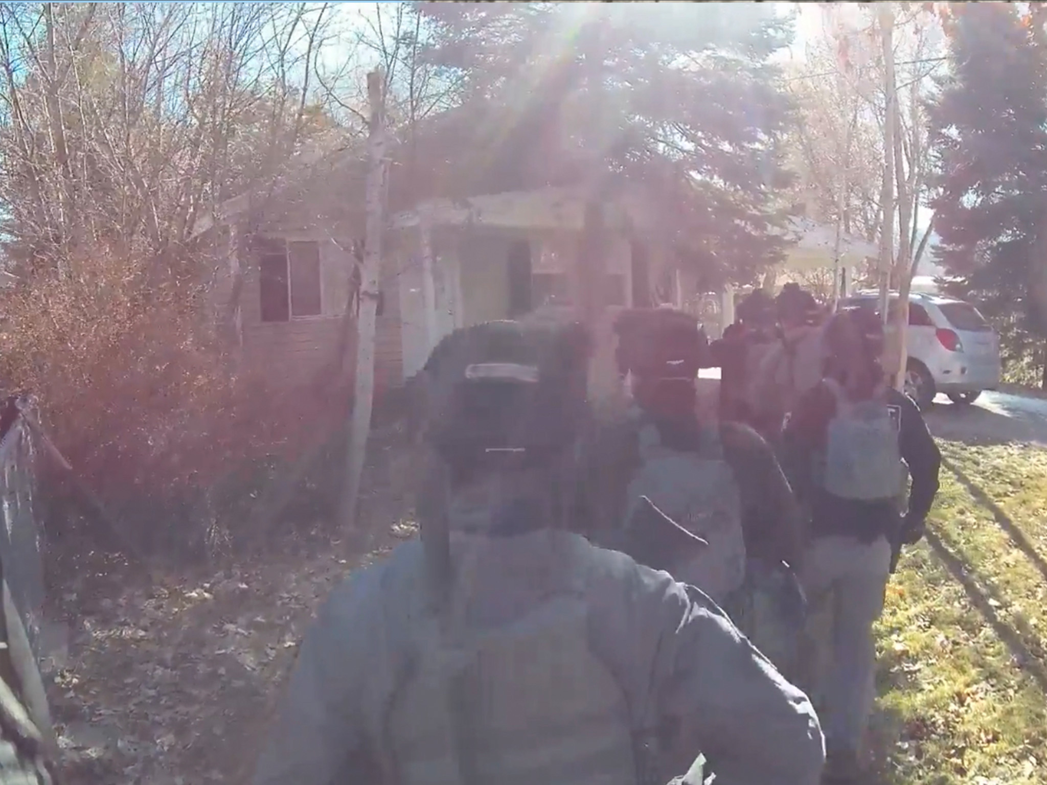 Members of the SERT team approach a house as part of a warrant service